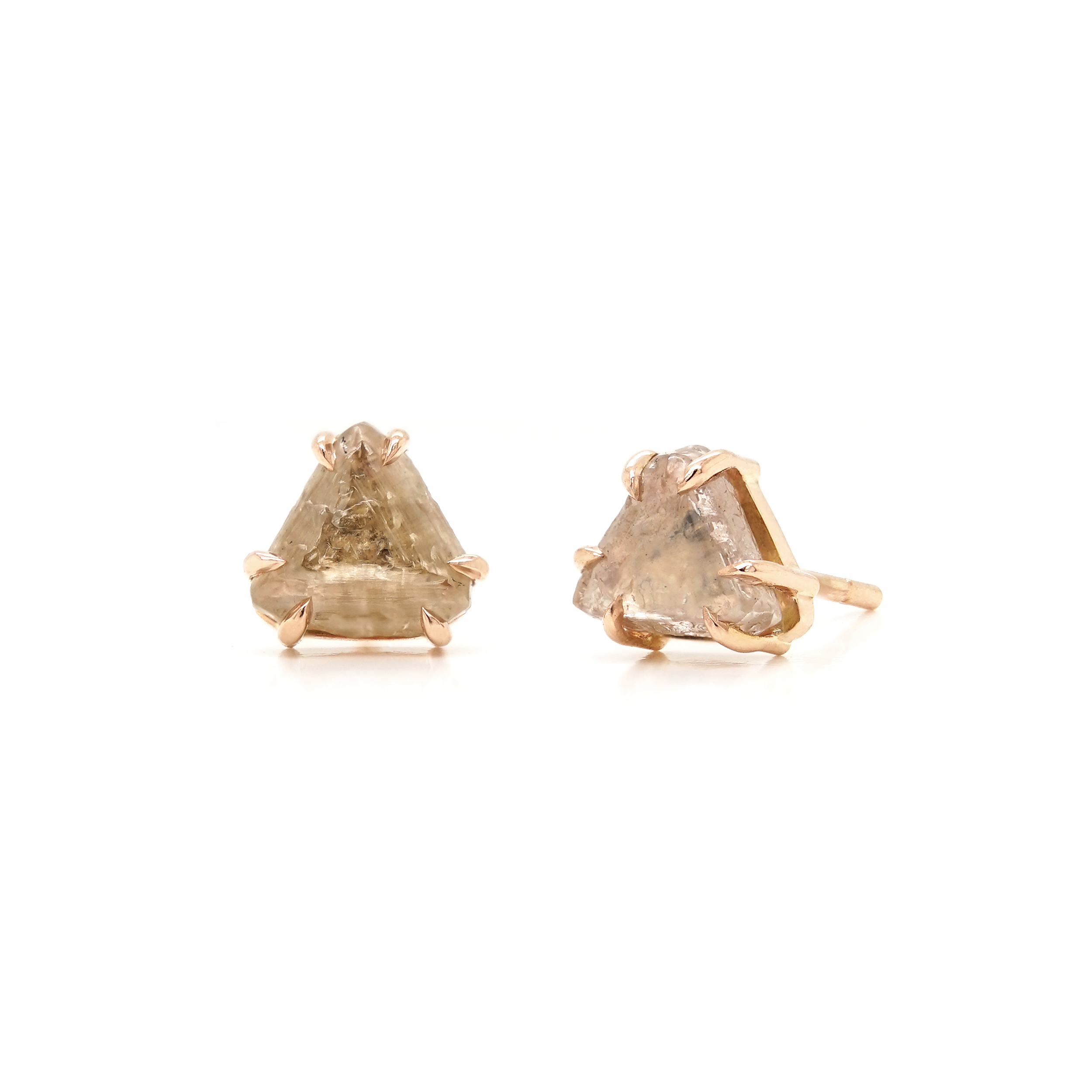 A pair of rose gold stud earrings featuring 2 triangle shaped rough champagne diamonds, each set in 6 griffin claws.